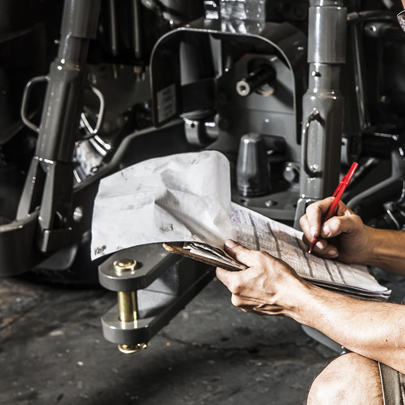 Man working on tractor suspension