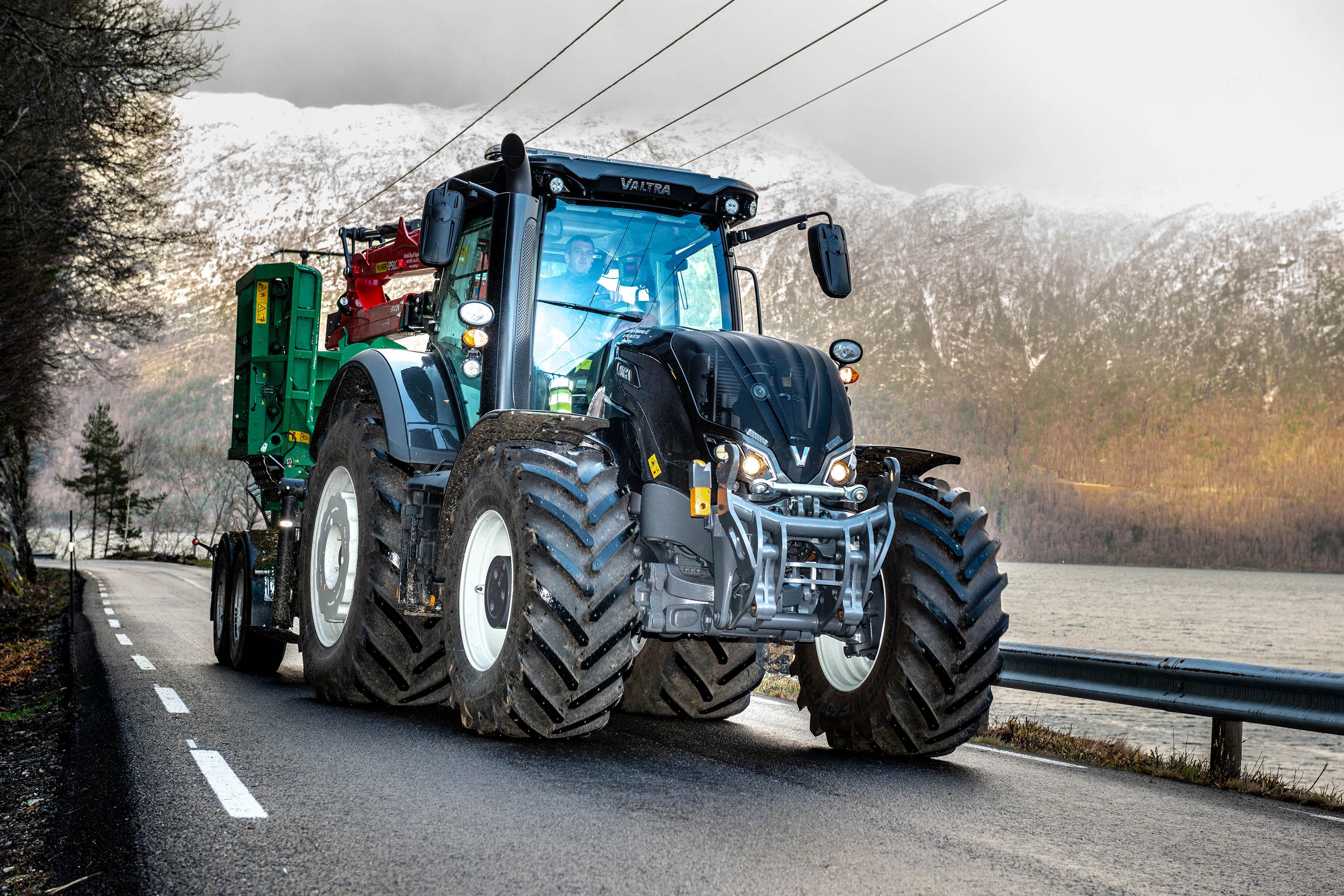 Valtra S394-traktoren med en stor flishogger og en kran